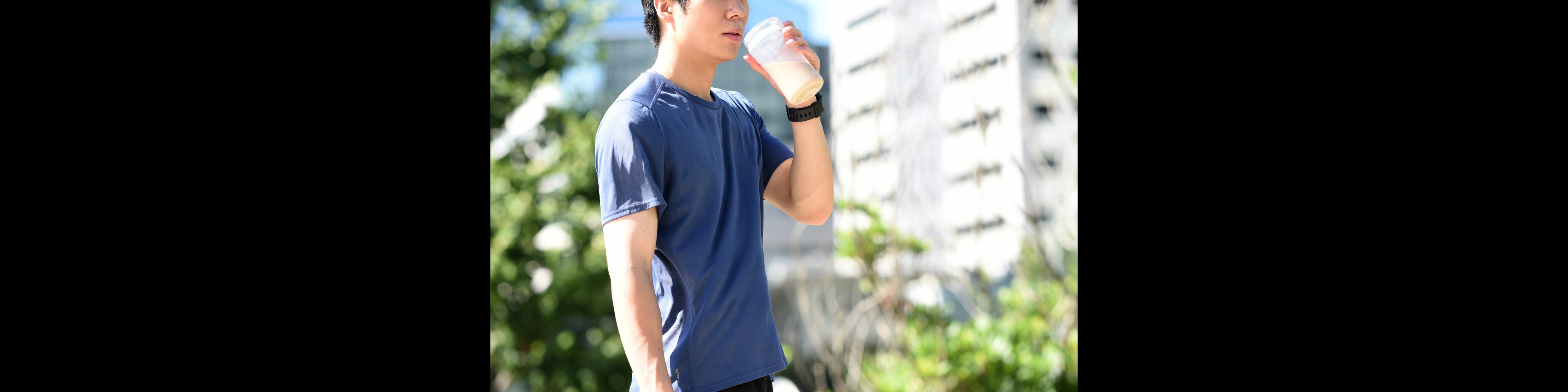 A balanced meal replacement shake next to whole food ingredients like oats, banana, and almonds, representing convenient, nutritious fuel in a single serving.